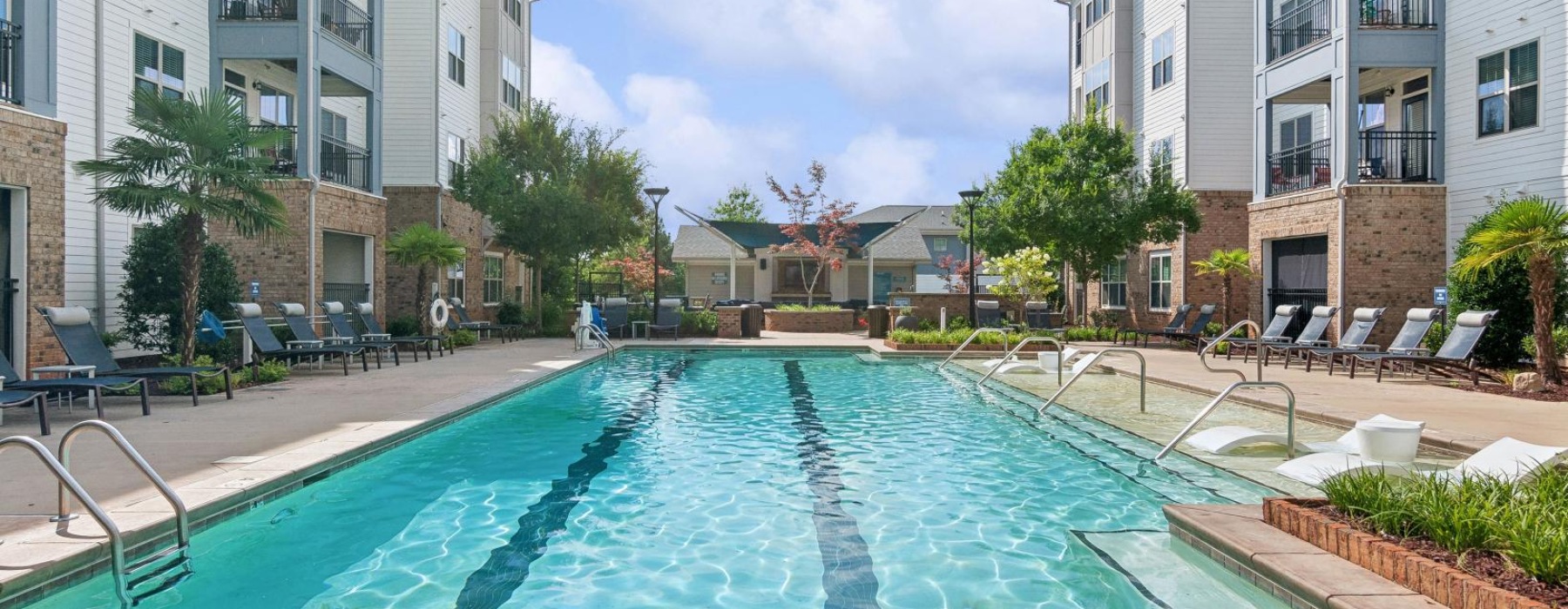 a swimming pool in a courtyard between buildings